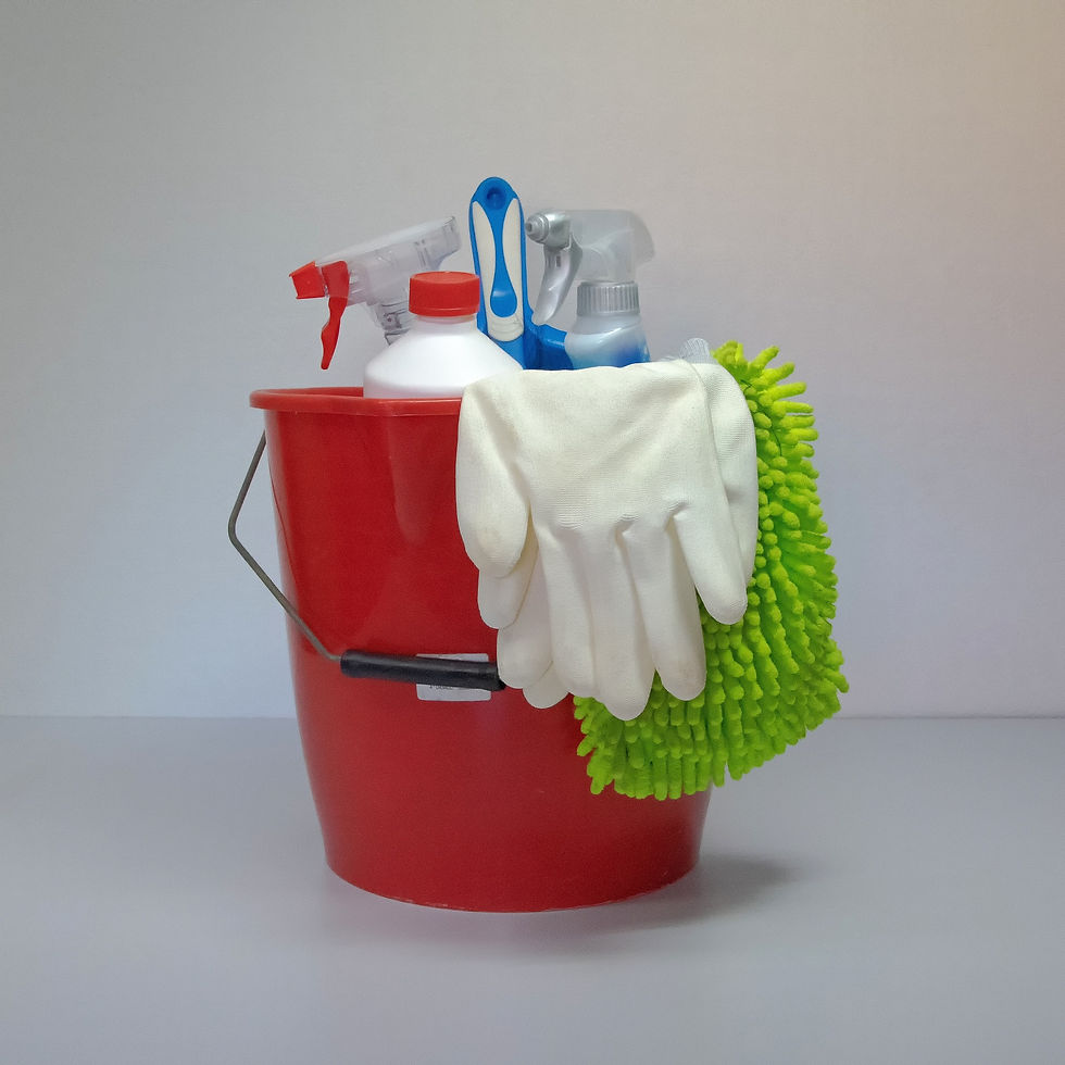 a red bucket with gloves, microfiber cloth, and spray bottles inside of it