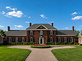 Large brick house, circular drive, landscaped island