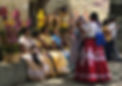 Young women in Oaxaca finish getting their hair and braids together, wearing traditional dress