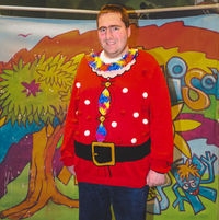 A person dressed up as Santa's helper