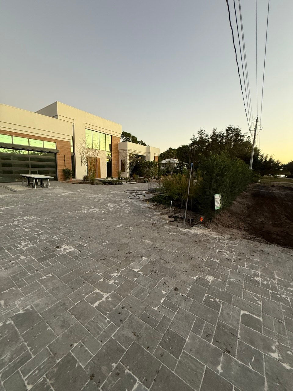 Modern building with large windows and paved driveway.