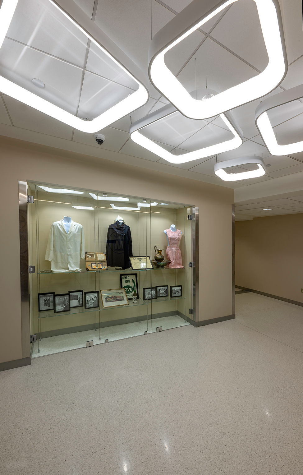 A new display case featuring archived materials from UPMC Passavant’s historied past is juxtaposed underneath modern lighting.
