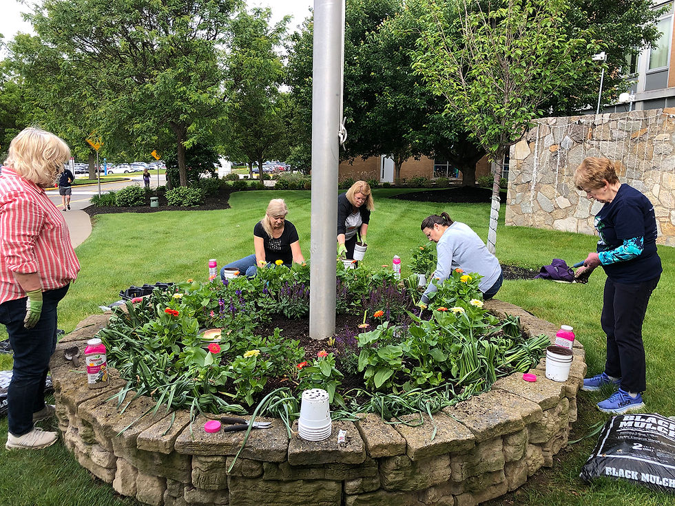 Ingomar Garden Club members planting around the flagpole at UPMC Passavant