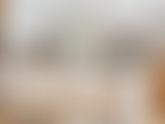 Luxury kitchen in a custom home with natural wood cabinets on the bottom and white on top. Includes a stunning waterfall island.