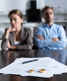 A picture of a man and a woman with divorce paperwork in front of them. Ruppert Law Firm LLC is a law firm in Monroeville, PA which represents men and women going through divorces throughout the Pittsburgh region.