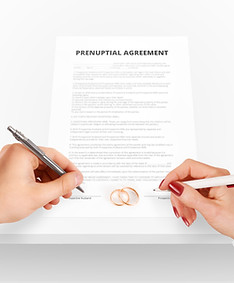 An image of a man's hand and a woman's hand signing a prenuptual agreement with wedding rings placed on the document. Ruppert Law Firm drafts prenup agreements of all sorts for any couple who believes they could benefit from such a contract. Prenups can save the heartbreak later on. Couples in Pittsburgh, Westmoreland county, Cranberry Twp, Beaver, and Washington Township turn to Ruppert Law Firm for Prenups.