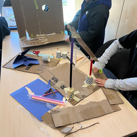Students building cardboard project