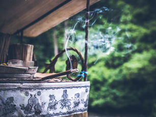 Sandalwood incense stick burning on outdoor altar