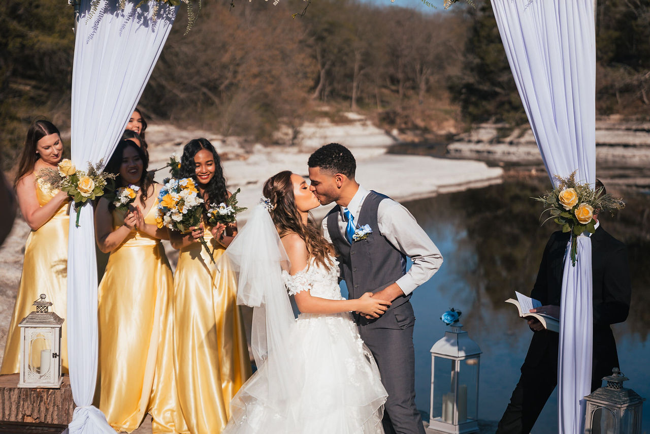 Pensacola Wedding Photographer Romantic, Affordable Photography in the Pensacola, Navarre, Destin, and Mobile area. Book Austen Hunter for your Wedding Day! Romantic Portrait of Newlywed Couple Embrace kiss shot spring wedding celebration