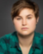 dramatic acting headshot of a young woman with short hair, masculine film look, plaid shirt. Pensacola acting headshot photographer austen hunter