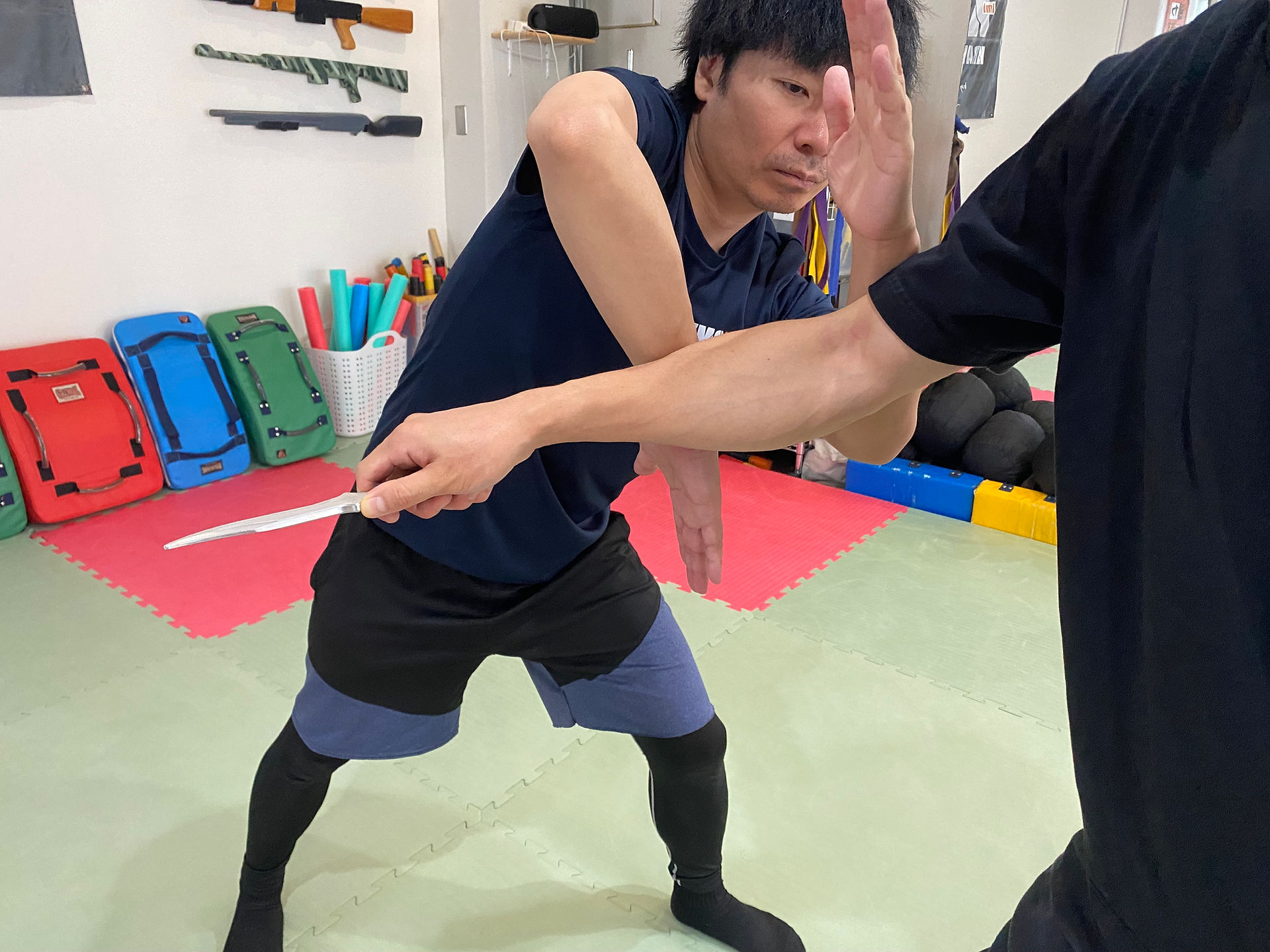 Double reverse forearm block against returning knife stab