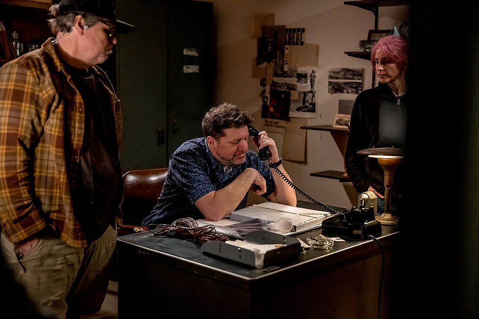 Adam White (center) directs on the set of "Photography"