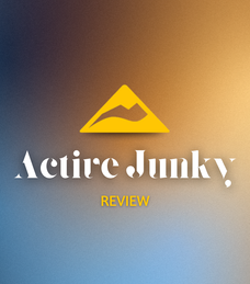 Gradient background with blue and orange hues. A yellow mountain logo above the text "Active Junky" and "REVIEW" in white and yellow.