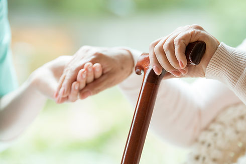 Elder person using wooden walking cane d