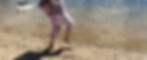 girl on sand next to pond