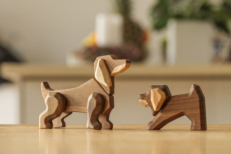 two wooden fablewood dogs looking playful