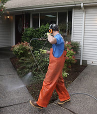 Husser Technician Pressure Washing Driveway