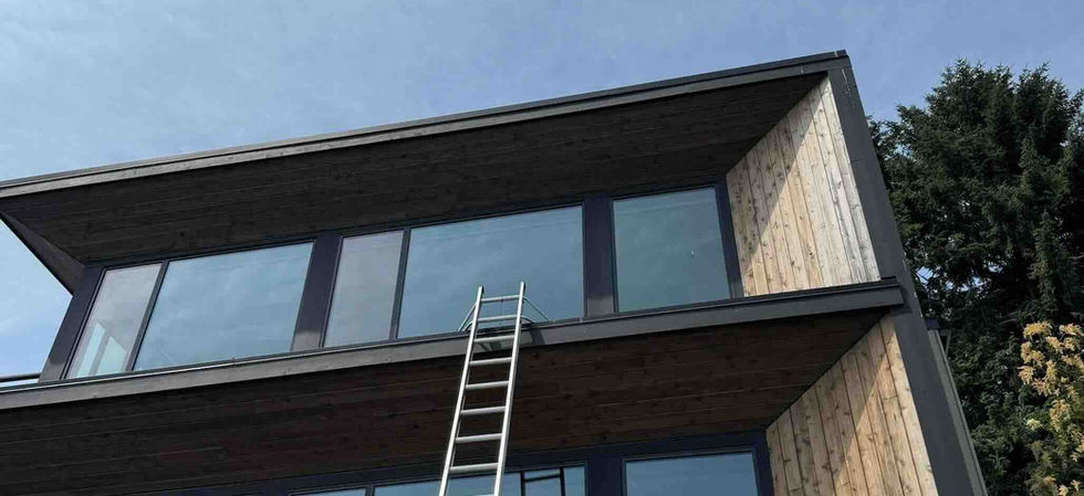 Cleaning third story windows at a West Seattle home overlooking the Puget Sound.
