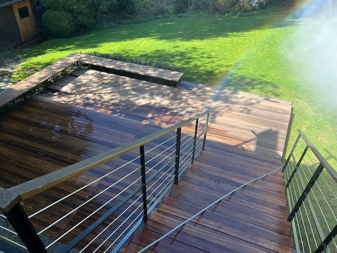 After photo of custom wood deck soft washing restoration in Seattle by Husser.
