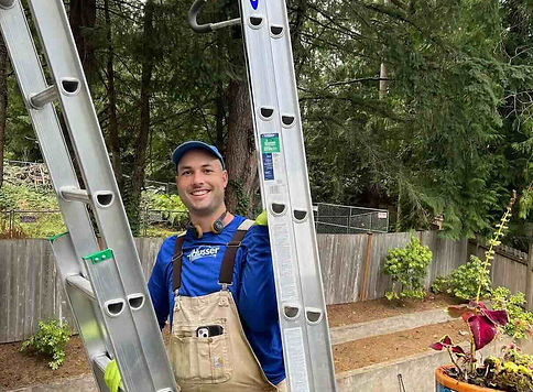 Husser owner carrying ladders at a gutter cleaning service in Seattle