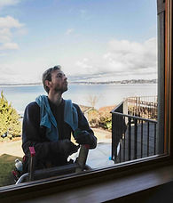Husser technician inspecting glass during Mercer Island post-construction window cleaning service