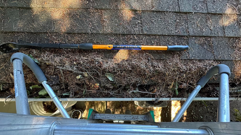 A gutter completely full of pine needles in Burien, WA during late summer