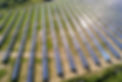 Aerial view of solar power plant on green field. Electric farm with panels for producing c