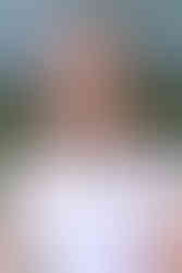 A woman in a white t shirt smiles