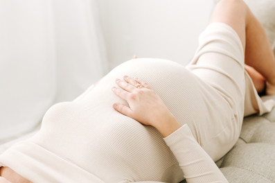 pregnant woman lying down and hand resting on her stomach