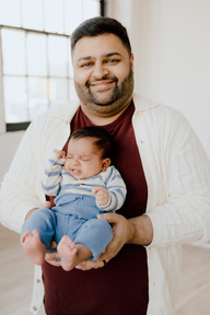 A man holds a baby boy