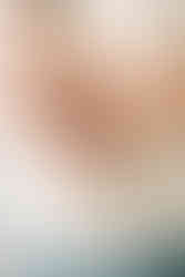 A man's arms as he holds a newbonr baby