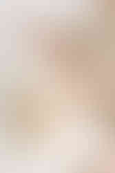 white cake on cake stand with baby's hands grabbing it