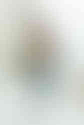 A pregnant woman holds a laughing toddler boy in her arms