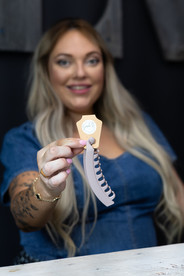 A woman holds out a hair claw clip