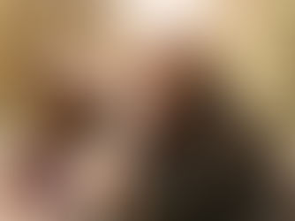 Two woman hug a dog in a forest