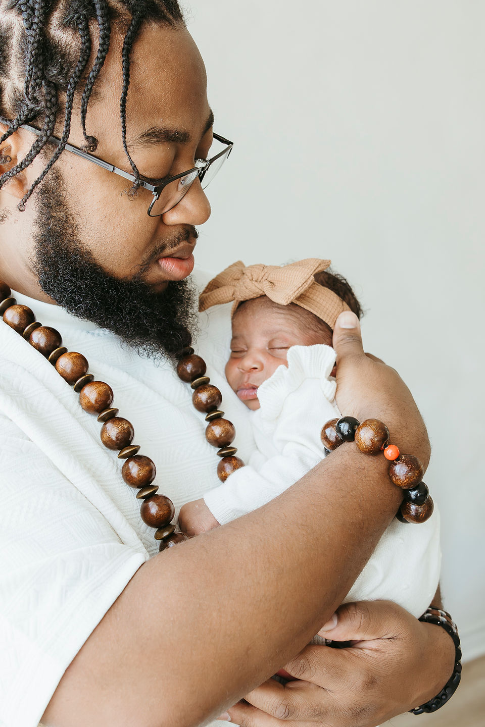A man holds a newborn baby to his chest