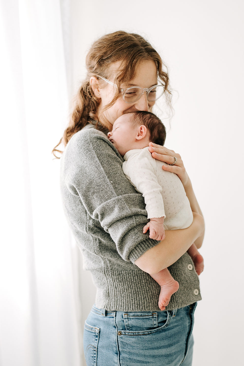 A woman holds a newborn baby to her chest