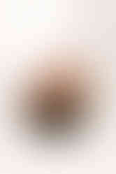 A newborn baby swaddled in a white blanket