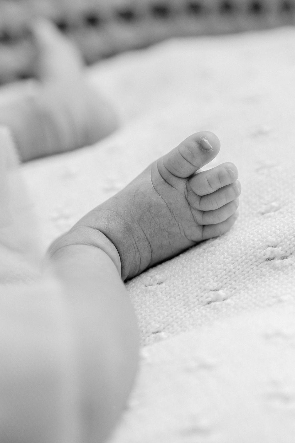 black and white photo of a baby's feet