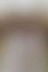 Two woman hold hands as one rests her head on the other shoulder