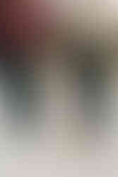 The bottom half of two woman as they hold hands and a dog sits between them