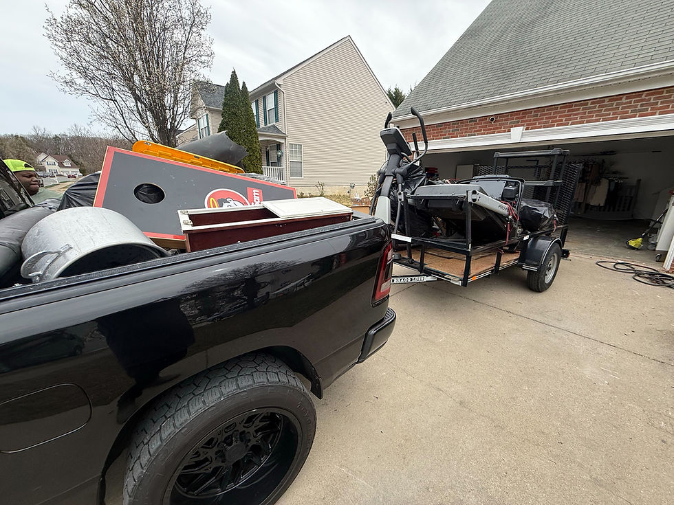 Fredericksburg's trusted junk removal company hauling bulky items into a truck and trailer.
