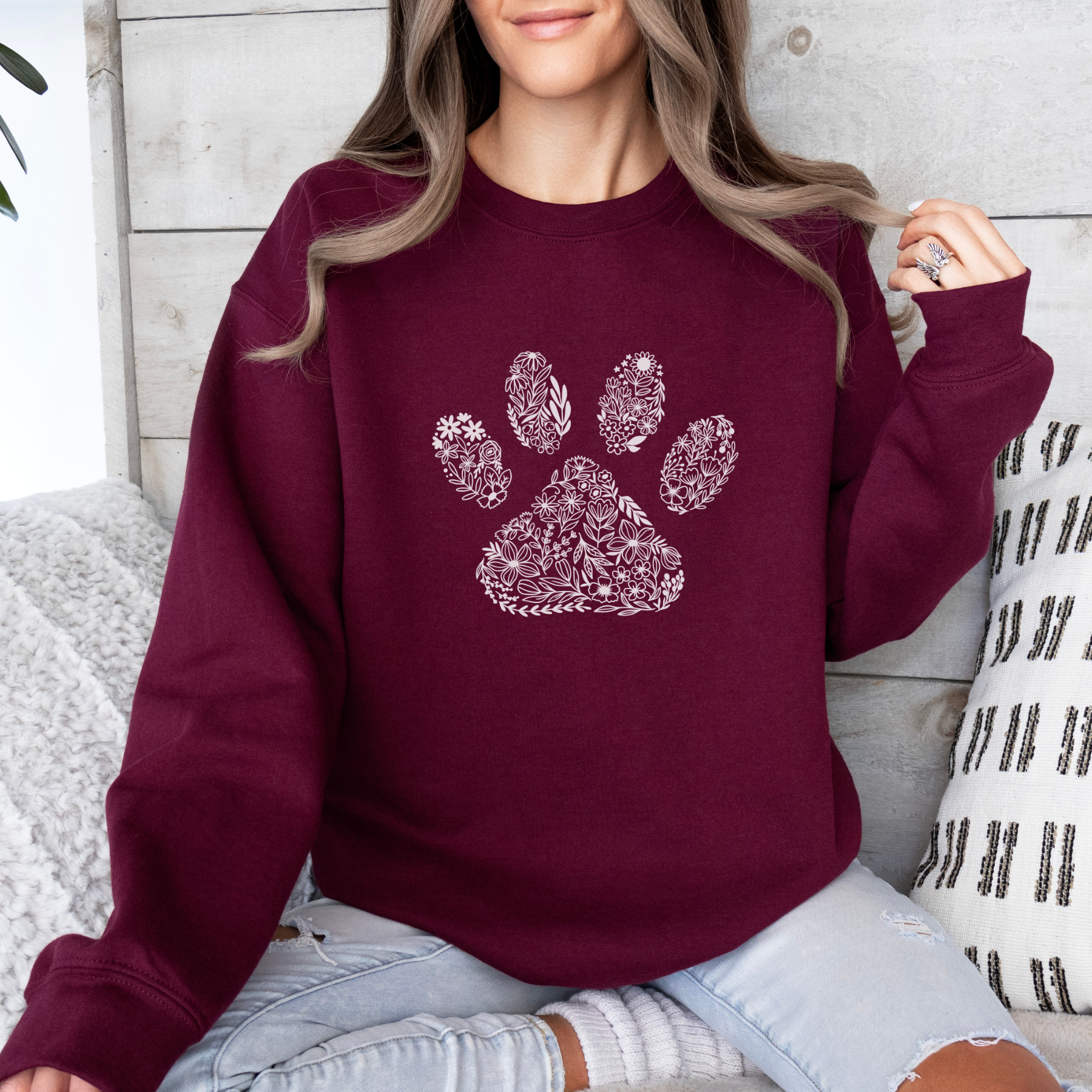 Maroon sweatshirt with the image of a paw with a floral design