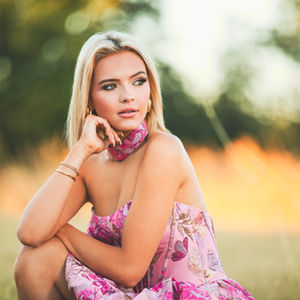 a man in a suit and white shirt smiles for the camera