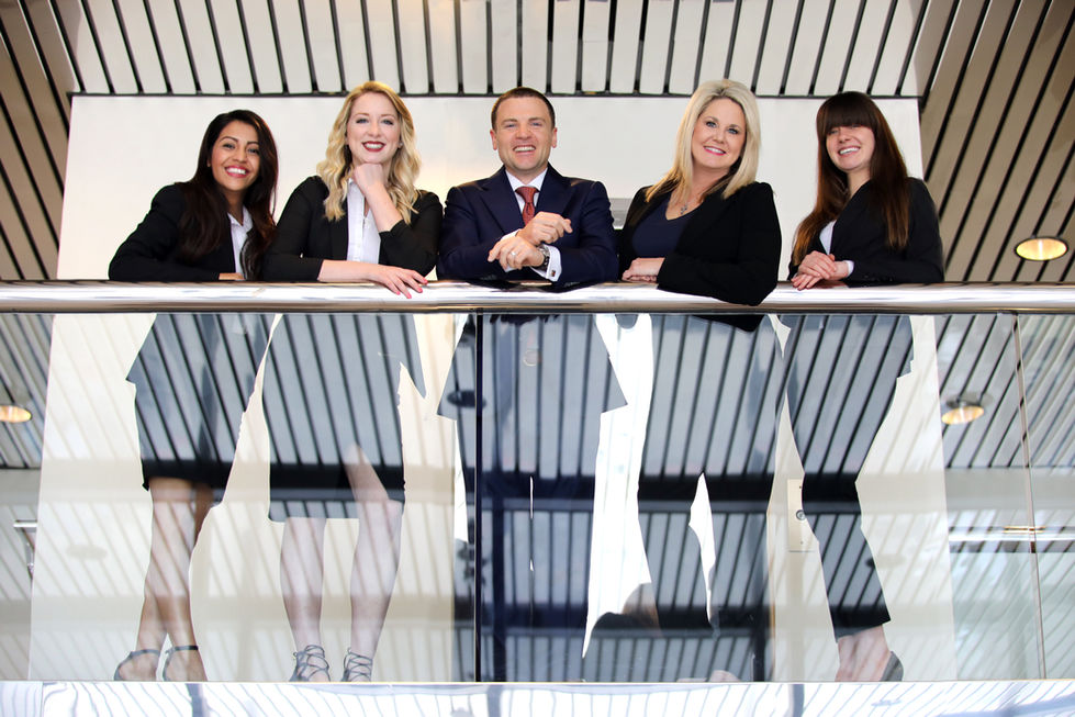 Portrait of a group of people standing next to each other on a balcony