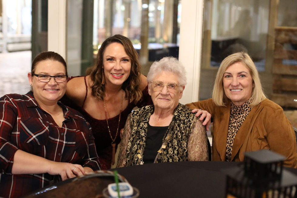 Portrait of three women are posing for a picture with an older woman