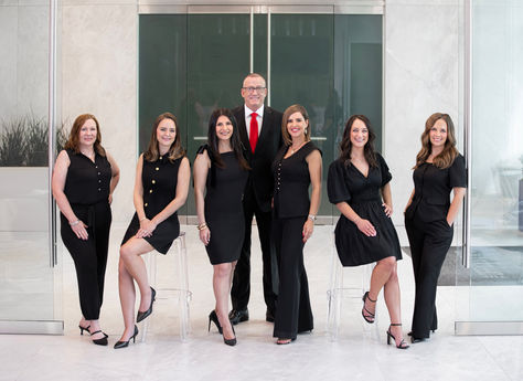 a group of women in black dresses are posing for a picture