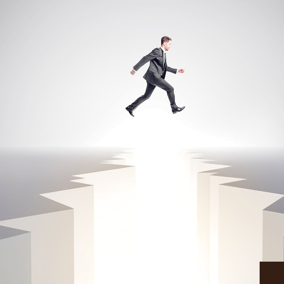businessman is jumping over the cracked gap