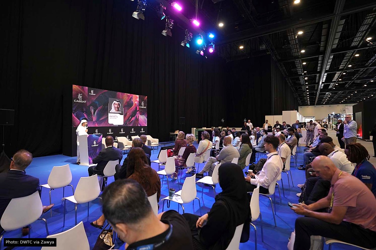 CABSAT branded stage and seated attendees at Dubai Exhibition Centre. Photo source: DWTC via Zawya.