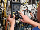 Fibre optic technician testing and fault finding on fibre cabling during advanced OTDR training.